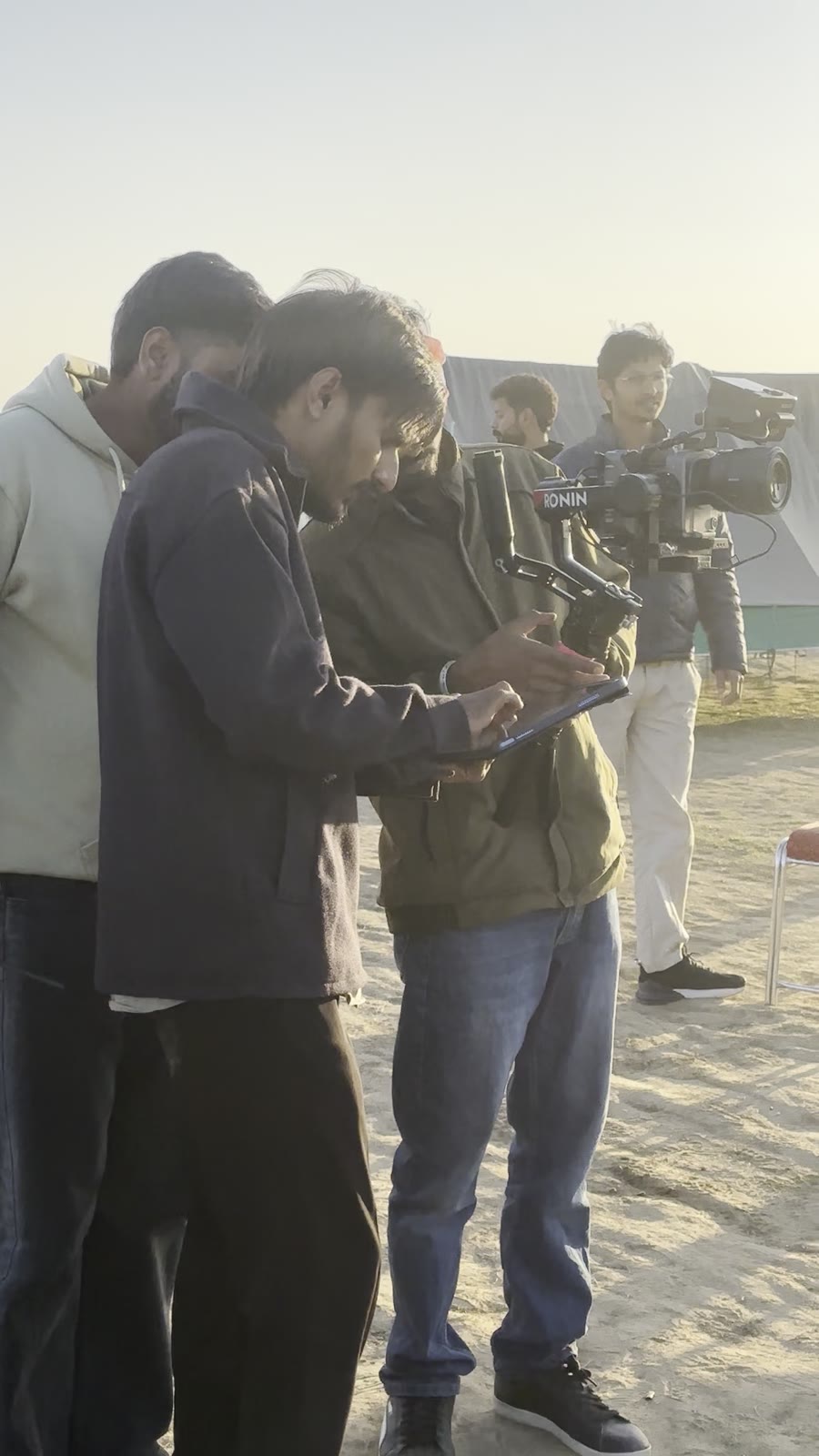 Crew reviewing shot on monitor during outdoor shoot